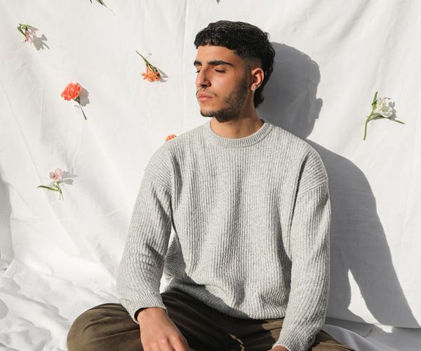 A person sitting in a calm meditation pose after a yoga session, looking serene.